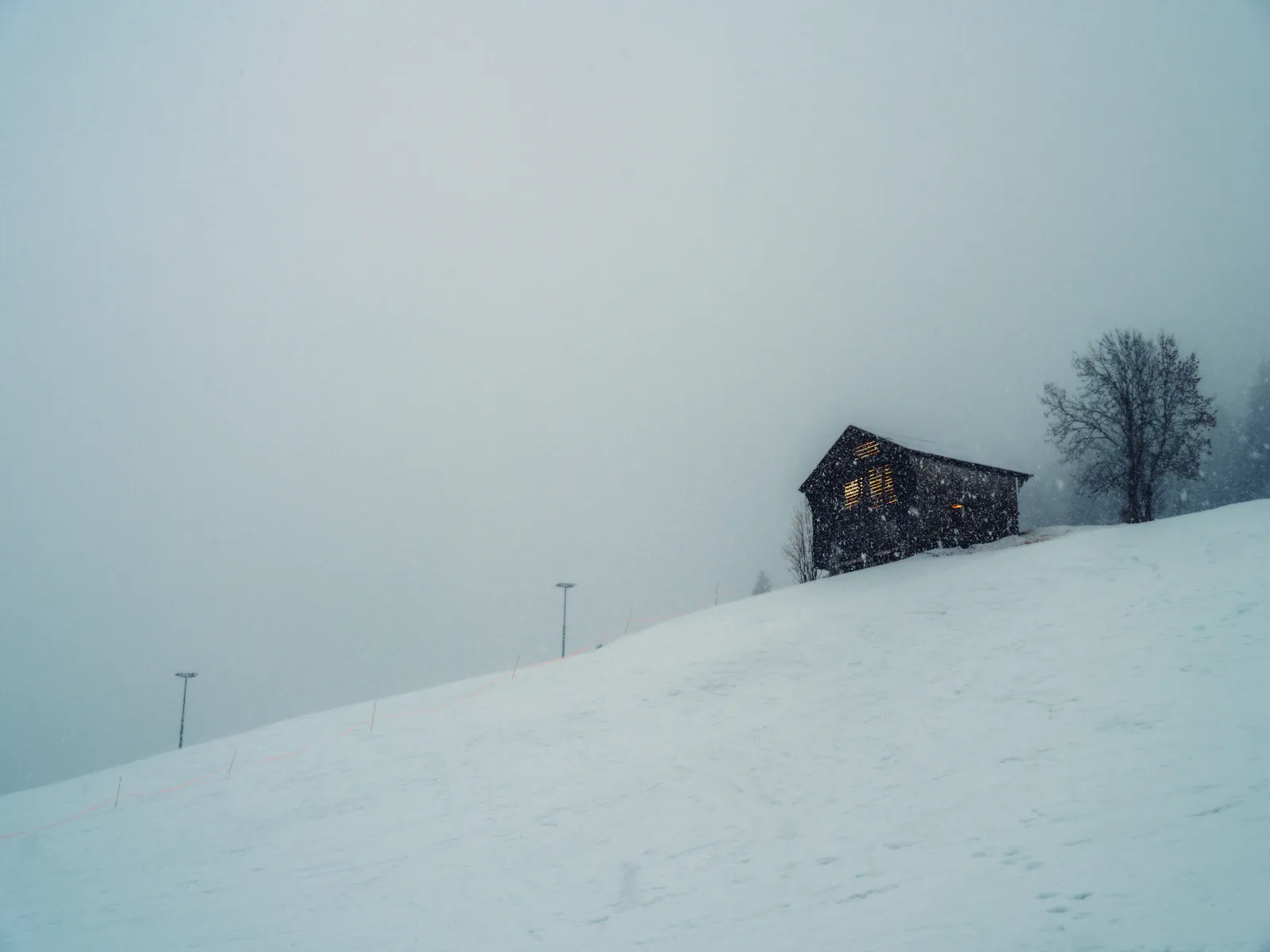 Alpine cabin in winter fog